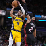 
              Indiana Pacers guard Tyrese Haliburton (0) shoots over Miami Heat guard Gabe Vincent (2) during the second half of an NBA basketball game in Indianapolis, Friday, Nov. 4, 2022. The Pacers defeated the Heat 101-99. (AP Photo/Michael Conroy)
            