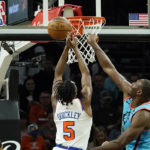 
              Phoenix Suns center Bismack Biyombo, right, blocks a shot by New York Knicks guard Immanuel Quickley (5) during the first half of an NBA basketball game in Phoenix, Sunday, Nov. 20, 2022. (AP Photo/Ross D. Franklin)
            