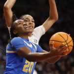 
              UCLA guard Charisma Osborne (20) shoots against South Carolina forward Victaria Saxton during the first half of an NCAA college basketball game in Columbia, S.C., Tuesday, Nov. 29, 2022. (AP Photo/Nell Redmond)
            