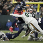 
              Tennessee Titans running back Derrick Henry (22) is stopped as he runs the ball by Green Bay Packers defensive tackle T.J. Slaton (93) during the first half of an NFL football game Thursday, Nov. 17, 2022, in Green Bay, Wis. (AP Photo/Morry Gash)
            