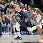 
              Dallas Mavericks guard Luka Doncic (77) loses control of the ball against Denver Nuggets guard Bones Hyland (3) during the second half of an NBA basketball game in Dallas, Sunday, Nov. 20, 2022. (AP Photo/LM Otero)
            