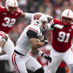 
              Wisconsin's Braelon Allen, center, carries the ball against Nebraska during the first half of an NCAA college football game Saturday, Nov. 19, 2022, in Lincoln, Neb. (AP Photo/Rebecca S. Gratz)
            