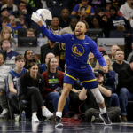 
              Golden State Warriors guard Stephen Curry cheers from the sideline during the fourth quarter of the team's NBA basketball game against the Minnesota Timberwolves on Sunday, Nov. 27, 2022, in Minneapolis. Curry was called for a technical foul. (AP Photo/Andy Clayton-King)
            