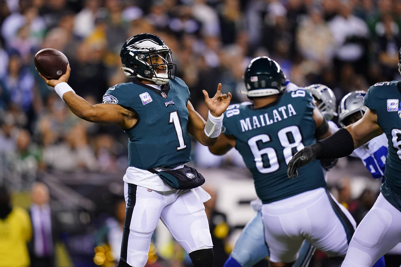 Philadelphia Eagles' Jalen Hurts looks to pass during the first half of an NFL football game agains...