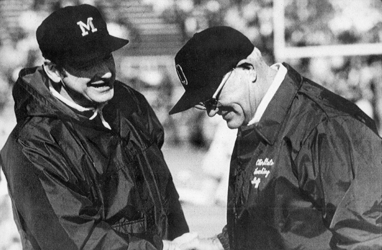 FILE - Michigan football coach Bo Schembechler, left, meets with Ohio State coach Woody Hayes in th...