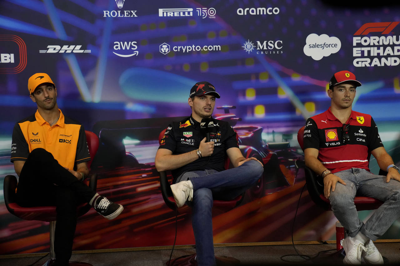 Red Bull driver Max Verstappen, center, sits between McLaren driver Daniel Ricciardo, of Australia,...