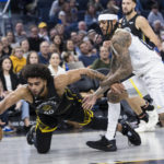 
              Golden State Warriors forward Anthony Lamb (40) gets possession of the ball in front of Utah Jazz guard Jordan Clarkson, front right, during the first half of an NBA basketball game in San Francisco, Friday, Nov. 25, 2022. (AP Photo/John Hefti)
            
