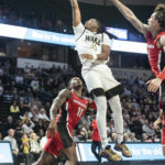 
              Wake Forest guard Daivien Williamson (4) goes in for a layup over Georgia guard Justin Hill (11) in the first half of an NCAA college basketball game Friday, Nov. 11, 2022, in Winston-Salem, N.C. (Allison Lee Isley/The Winston-Salem Journal via AP)
            