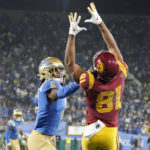 
              Southern California wide receiver Kyle Ford, right, catches a touchdown pass as UCLA defensive back John Humphrey defends during the second half of an NCAA college football game Saturday, Nov. 19, 2022, in Pasadena, Calif. (AP Photo/Mark J. Terrill)
            