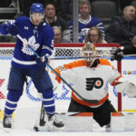 
              Philadelphia Flyers goaltender Felix Sandstrom (32) watches the puck as Toronto Maple Leafs' Michael Bunting (58) stands in front during the third period of an NHL hockey game Wednesday, Nov. 2, 2022, in Toronto. (Frank Gunn/The Canadian Press via AP)
            