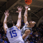 
              South Carolina-Upstate's Trae Broadnax, right, shoots over Duke's Ryan Young (15) during the first half of an NCAA college basketball game in Durham, N.C., Friday, Nov. 11, 2022. (AP Photo/Ben McKeown)
            