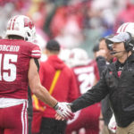 
              Wisconsin interim head coach Jim Leonhard greats safety John Torchio (15) after a play in the first half of an NCAA college football game against Maryland, Saturday, Nov. 5, 2022, in Madison, Wis. (AP Photo/Andy Manis)
            