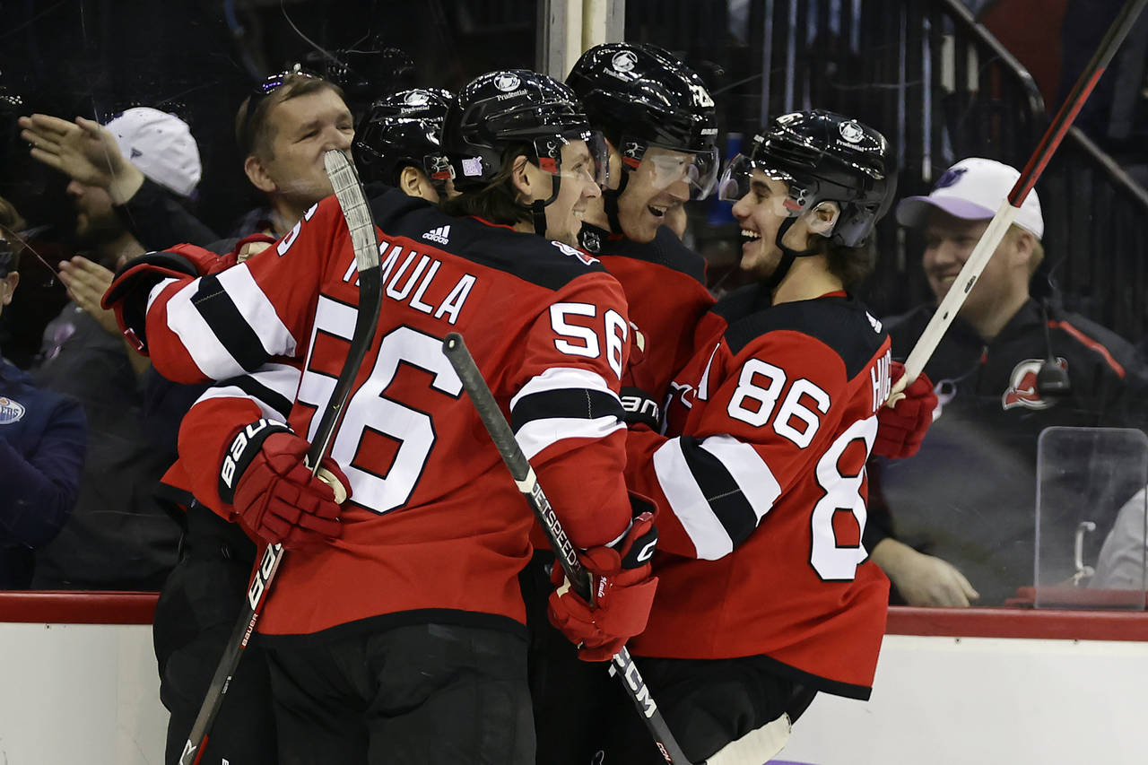 FILE - New Jersey Devils defenseman Damon Severson (28) celebrates with teammates after scoring a g...