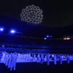 
              FILE - Drones perform a globe above the roof of the stadium during the opening ceremony in the Olympic Stadium at the 2020 Summer Olympics, Friday, July 23, 2021, in Tokyo, Japan.  Creative director Marco Balich, reveals to The Associated Press that he has been working for a year on a 30-minute show that will run ahead of the Soccer World Cup 2022 opening game between Qatar and Ecuador. He says local organizers "wanted to create a real show, which FIFA is not accustomed to.” (AP Photo/Natacha Pisarenko, File)
            