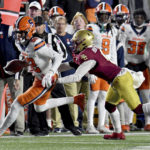 
              Syracuse wide receiver Damien Alford, left, is chased down the sideline and tackled by Boston College's CJ Burton, right, during the first half of an NCAA college football game, Saturday, Nov. 26, 2022, in Boston. (AP Photo/Mark Stockwell)
            