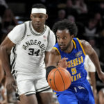 
              Morehead State's Branden Maughmer (5) heads down the court ahead of Vanderbilt forward Lee Dort (34) in the second half of an NCAA college basketball game Friday, Nov. 18, 2022, in Nashville, Tenn. (AP Photo/Mark Humphrey)
            