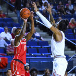 
              Houston guard Marcus Sasser (0) shoots a 3-pointer against Saint Joseph's guard Erik Reynolds II during the first half of an NCAA college basketball game at the Veterans Classic, Friday, Nov. 11, 2022, in Annapolis, Md. (AP Photo/Terrance Williams)
            