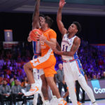 
              In a photo provided by Bahamas Visual Services, Tennessee's Santiago Vescovi drives to the basket as Kansas' MJ Rice (11) and KJ Adams Jr., back left, defend during an NCAA college basketball game in the Battle 4 Atlantis at Paradise Island, Bahamas, Friday, Nov. 25, 2022. (Tim Aylen/Bahamas Visual Services via AP)
            