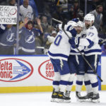 
              Tampa Bay Lightning left wing Nicholas Paul, left, center Steven Stamkos (91) and defenseman Victor Hedman (77) celebrate after Stamkos scored the winning goal in overtime of an NHL hockey game against the Buffalo Sabres, Monday, Nov. 28, 2022, in Buffalo, N.Y. (AP Photo/Joshua Bessex)
            