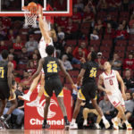 
              Nebraska's Sam Griesel (5) dunks over Arkansas-Pine Bluff's Brahm Harris (14), Shaun Doss Jr. (21), Robert Lewis (22) and AC Curry (24) during the second half of an NCAA college basketball game on Sunday, Nov. 20, 2022, in Lincoln, Neb. (AP Photo/Rebecca S. Gratz)
            