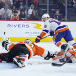 
              New York Islanders' Anthony Beauvillier (18) cannot get a shot past Philadelphia Flyers' Carter Hart (79) and Nick Seeler (24) during the third period of an NHL hockey game, Tuesday, Nov. 29, 2022, in Philadelphia. (AP Photo/Matt Slocum)
            