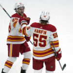 
              Calgary Flames defenseman Noah Hanifin (55) is congratulated by Andrew Mangiapane (88) after his goal against the Boston Bruins during the first period of an NHL hockey game Thursday, Nov. 10, 2022, in Boston. (AP Photo/Charles Krupa)
            