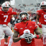 
              Ohio State wide receiver Kamryn Babb, center, celebrates his touchdown against Indiana with teammates quarterback C.J. Stroud, left, and running back Dallan Hayden during the second half of an NCAA college football game Saturday, Nov. 12, 2022 in Columbus, Ohio. Ohio State won 56-14. (AP Photo/Paul Vernon)
            