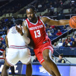 
              Houston forward J'Wan Roberts (13) drives to the basket past Saint Joseph's center Charles Coleman during the first half of an NCAA college basketball game at the Veterans Classic, Friday, Nov. 11, 2022, in Annapolis, Md. (AP Photo/Terrance Williams)
            