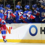 
              New York Rangers left wing Alexis Lafrenière (13) fist bumps the bench after scoring a goal during the first period of an NHL hockey game against the Edmonton Oilers, Saturday, Nov. 26, 2022, in New York. (AP Photo/Julia Nikhinson)
            