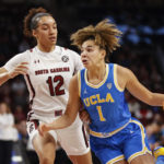 
              UCLA guard Kiki Rice (1) drives to the basket against South Carolina guard Brea Beal (12) during the first half of an NCAA college basketball game in Columbia, S.C., Tuesday, Nov. 29, 2022. (AP Photo/Nell Redmond)
            