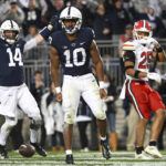 
              Penn State running back Nicholas Singleton (10) and quarterback Sean Clifford (14) celebrate a touchdown as Maryland defensive back Beau Brade (25) looks on during the first half of an NCAA college football game, Saturday, Nov. 12, 2022, in State College, Pa. (AP Photo/Barry Reeger)
            