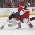 
              Washington Capitals center Nic Dowd (26) and Detroit Red Wings defenseman Filip Hronek (17) get tangled up during the first period of an NHL hockey game, Thursday, Nov. 3, 2022, in Detroit. (AP Photo/Carlos Osorio)
            