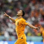 
              Cody Gakpo of the Netherlands celebrates after scoring his side's opening goal during the World Cup group A soccer match between the Netherlands and Qatar, at the Al Bayt Stadium in Al Khor , Qatar, Tuesday, Nov. 29, 2022. (AP Photo/Moises Castillo)
            