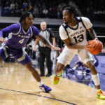 
              Butler guard Jayden Taylor (13) drives on Kansas State guard Tykei Greene (4) in the first half of an NCAA college basketball game in Indianapolis, Wednesday, Nov. 30, 2022. (AP Photo/Michael Conroy)
            
