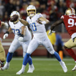 
              Los Angeles Chargers quarterback Justin Herbert (10) passes while pressured by San Francisco 49ers defensive end Charles Omenihu (94) and defensive end Nick Bosa (97) during the first half of an NFL football game in Santa Clara, Calif., Sunday, Nov. 13, 2022. (AP Photo/Jed Jacobsohn)
            