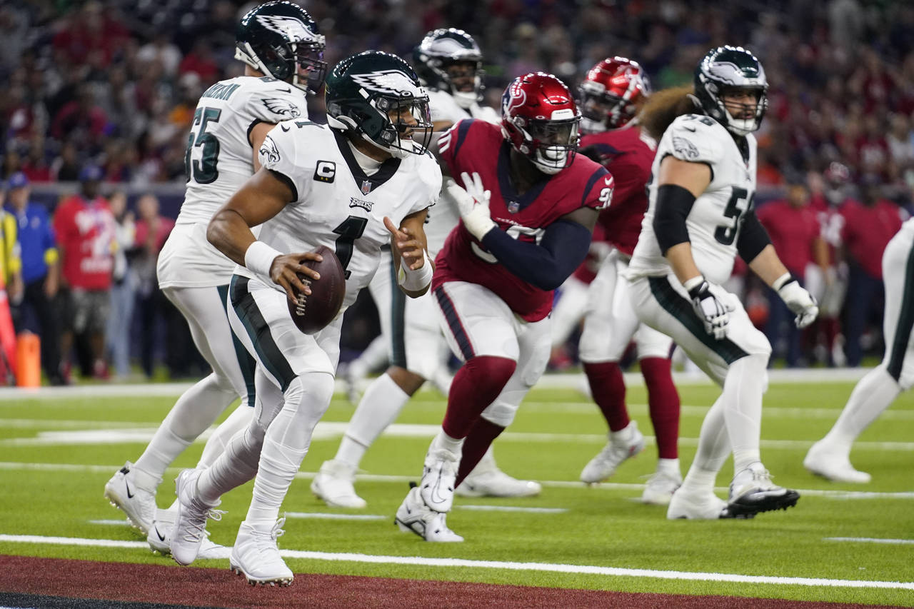Philadelphia Eagles quarterback Jalen Hurts (1) scrambles in the end zone in the second half of an ...