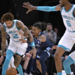 
              Charlotte Hornets guard Kelly Oubre Jr., left, and Memphis Grizzlies guard Ja Morant struggle for control of the ball during the first half of an NBA basketball game Friday, Nov. 4, 2022, in Memphis, Tenn. (AP Photo/Brandon Dill)
            
