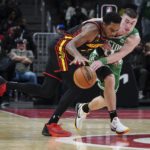 
              Boston Celtics guard Payton Pritchard (11) reaches in to steal the ball from Atlanta Hawks guard Aaron Holiday (3) during the second half of an NBA basketball game Wednesday, Nov. 16, 2022 in Atlanta. (AP Photo/John Bazemore)
            