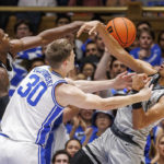 
              South Carolina-Upstate's Floyd Rideau Jr., right, and Khydarius Smith, left, compete with Duke's Kyle Filipowski (30) for a rebound during the first half of an NCAA college basketball game in Durham, N.C., Friday, Nov. 11, 2022. (AP Photo/Ben McKeown)
            