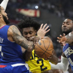 
              Los Angeles Clippers guard Amir Coffey, left, and guard John Wall, right, grapple for the ball with Utah Jazz guard Collin Sexton during the first half of an NBA basketball game Monday, Nov. 21, 2022, in Los Angeles. (AP Photo/Mark J. Terrill)
            