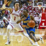 
              Morehead State guard Mark Freeman (0) drives the ball around the defense of Indiana guard Jalen Hood-Schifino (1) during the first half of an NCAA college basketball game, Monday, Nov. 7, 2022, in Bloomington, Ind. (AP Photo/Doug McSchooler)
            