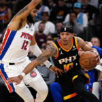 
              Phoenix Suns' Damion Lee (10) drives around Detroit Pistons' Isaiah Livers (12) during the second half of an NBA basketball game in Phoenix, Friday, Nov. 25, 2022. (AP Photo/Darryl Webb)
            