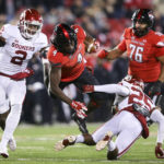 
              Texas Tech running back SaRodorick Thompson (4) flies through the air after being hit by Oklahoma defensive back Justin Broiles (25) during the second quarter of an NCAA college football game in Lubbock, Texas, Saturday, Nov. 26, 2022. (Ian Maule/Tulsa World via AP)
            