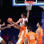 
              In a photo provided by Bahamas Visual Services, Tennessee's Jonas Aidoo, center, battles for a rebound during an NCAA college basketball game against Southern California in the Battle 4 Atlantis at Paradise Island, Bahamas, Thursday, Nov. 24, 2022. (Tim Aylen/Bahamas Visual Services via AP)
            