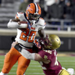
              Syracuse's LeQuint Allen is tackled by Boston College's Vinny DePalma during the first half of an NCAA college football game Saturday, Nov. 26, 2022, in Boston. (AP Photo/Mark Stockwell)
            