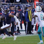 
              Chicago Bears quarterback Justin Fields (1) runs the ball as Miami Dolphins safety Jevon Holland (8) closes in during the second half of an NFL football game, Sunday, Nov. 6, 2022 in Chicago. (AP Photo/Charles Rex Arbogast)
            