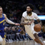 
              New Orleans Pelicans forward Brandon Ingram (14) drives the lane past Golden State Warriors guard Donte DiVincenzo (0) in the first half of an NBA basketball game in New Orleans, Monday, Nov. 21, 2022. (AP Photo/Gerald Herbert)
            