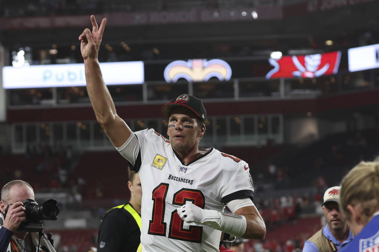 Tampa Bay Buccaneers quarterback Tom Brady (12) waves to spectators after an NFL football game betw...
