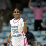 
              FILE - North Carolina guard Deja Kelly (25) reacts during the first half of an NCAA college basketball game against Louisville in Chapel Hill, N.C., Thursday, Feb. 17, 2022. Some star women’s players have already decided to stay in school rather than make their earliest possible jump to the WNBA and more are on the way with NIL deals and chartered travel offering appeal compared to rookie salaries and commercial flights in the WNBA. (AP Photo/Gerry Broome, File)
            