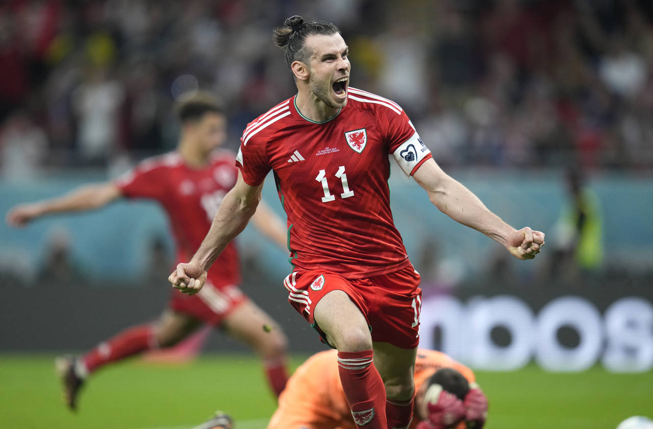 Wales' Gareth Bale celebrates after scoring his side's opening goal during the World Cup, group B s...